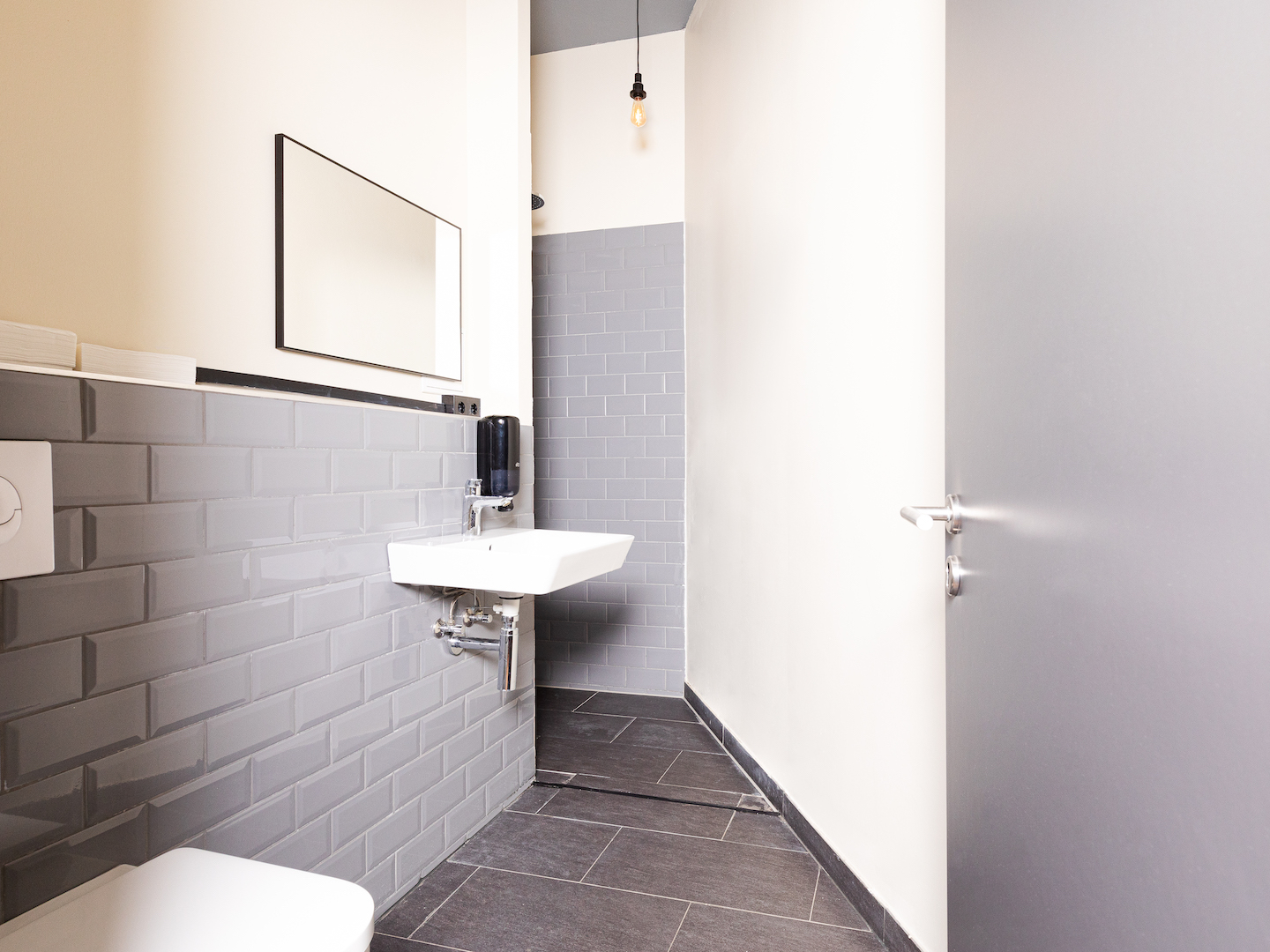 Bathroom with sink, shower and toilet in the Coffee Inn hostel Berlin